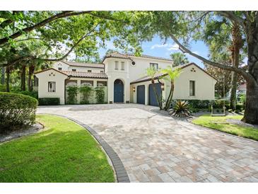 Stunning Mediterranean-style home featuring a clay tile roof and beautiful paver driveway at 9809 Covent Garden Dr # Drive, Orlando, FL 32827