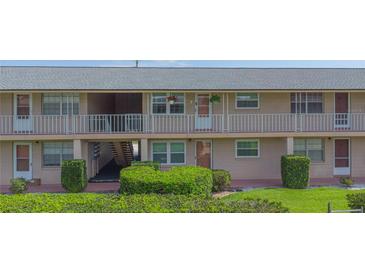 Attractive two-story building with a pleasant entrance and well-maintained landscaping at 1100 E Caroline St # 204, Tavares, FL 32778