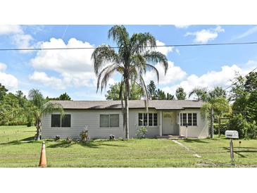 Charming single-story home featuring a well-maintained lawn and inviting curb appeal at 1390 E Airport Blvd, Sanford, FL 32773