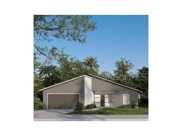 Modern home with a gray exterior, well-manicured landscaping, and an attached garage at 15300 Sw 62Nd Ct, Ocala, FL 34473