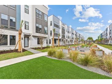 Beautiful townhome community with manicured landscaping, palm trees, and modern architecture at 2217 Valentine Aly, Orlando, FL 32804