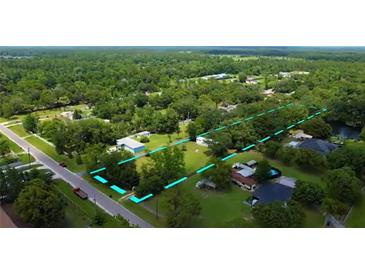 An aerial view showcasing the property's boundaries, lush greenery, and proximity to the surrounding area at 2623 8Th St, Orlando, FL 32820