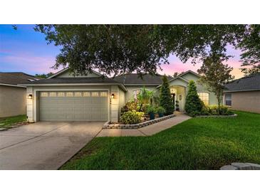 Charming single-story home featuring a well-manicured lawn and an attached two-car garage at 544 Lake Sumner Dr, Groveland, FL 34736