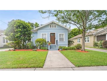 Charming light blue single-story home with well-manicured lawn and front yard at 638 Clayton St, Orlando, FL 32804