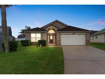Charming single-story home with well-maintained lawn, attached garage, and appealing curb appeal at 8102 Pomo Dr, Kissimmee, FL 34747