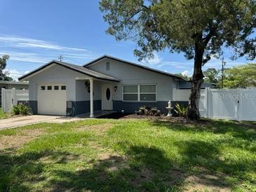 Well maintained single-story home features a lush green lawn and mature landscaping at 2315 Pembrook Dr, Orlando, FL 32810