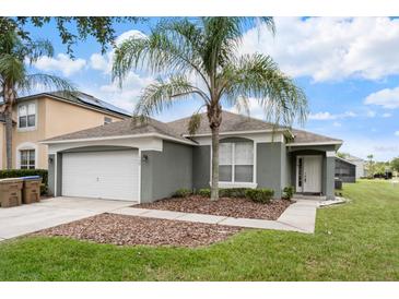 Charming single-story home with a well-manicured lawn and a beautiful palm tree in the front yard at 150 Barefoot Beach Way, Kissimmee, FL 34746