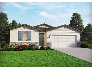 Charming single-story home featuring a stone facade, teal shutters, and a well-manicured lawn at 2069 Rosewood Dr, Bartow, FL 33830