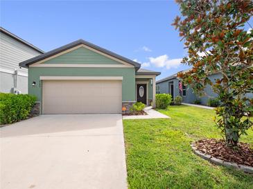Charming one-story home featuring a two-car garage, manicured lawn, and inviting curb appeal at 2249 Litchfield Loop, Deland, FL 32720