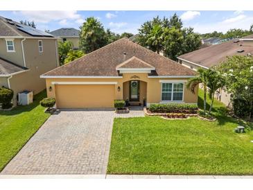 Charming single-story home with a well-manicured lawn and a paved driveway at 2733 Big Timber Dr, Kissimmee, FL 34758