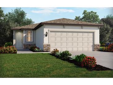 Charming single-story home featuring a neutral color palette, large garage, stone accents, and a well-manicured lawn with colorful landscaping at 2786 Virginia Pine Dr, Bartow, FL 33830