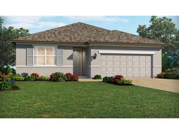 Charming one-story home with a well-manicured lawn and neutral-colored exterior with attached two car garage at 3117 Legends Preserve Dr, Daytona Beach, FL 32124
