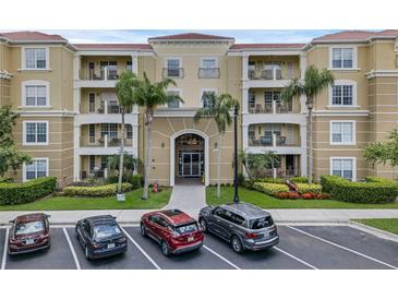Inviting condo exterior with a well-maintained facade, lush landscaping, and convenient parking spaces at 4804 Cayview Ave # 20512, Orlando, FL 32819