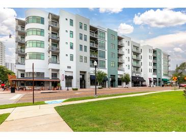 Multi-story condominium building featuring an attractive color scheme, well-maintained landscaping, and convenient commercial space at 10 N Summerlin Ave # 14, Orlando, FL 32801