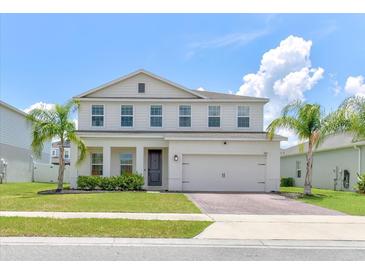 Charming two-story home with well-manicured lawn, lush landscaping, and a two car garage at 2149 Tudor Rose Dr, Sanford, FL 32773