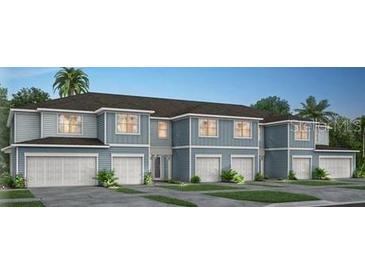 Attractive townhouse exterior with light blue siding, white trim, and individual one-car garages at 2330 Vision St, Davenport, FL 33896