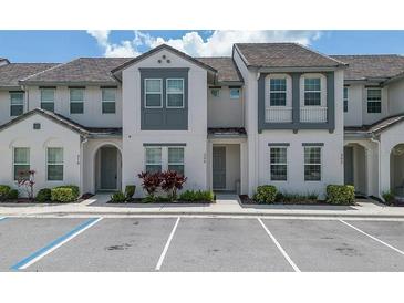 Charming two-story townhome features neutral paint, tile roof, and well-maintained landscaping at 306 Captiva Dr, Davenport, FL 33896