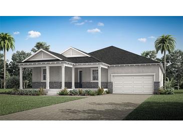 Charming single-story home featuring a covered front porch, two-car garage, and neat landscaping at 308 Free Range Dr, Clermont, FL 34715