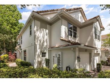Corner view of a two-story home showing the architectural details and manicured landscaping at 6874 Slaven Dr, Orlando, FL 32819