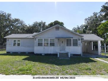 Charming single-story home with a front lawn and a carport for convenient parking at 1324 S Summerlin Ave, Sanford, FL 32771