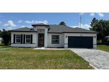 Charming single-Gathering home with a modern design, well-manicured lawn, and paved driveway at 482 Marion Oaks Mnr, Ocala, FL 34473