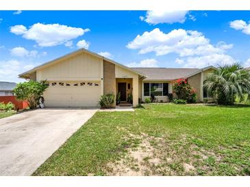 Charming single-story home with attached garage and well-maintained lawn at 1165 Indian Ridge E Trl, Kissimmee, FL 34747