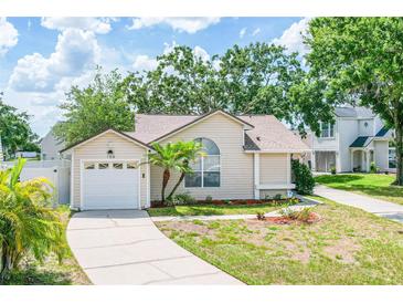 Charming single-story home featuring a well-manicured lawn, a one-car garage, and welcoming curb appeal at 126 Spanish Moss Ct, Orlando, FL 32828