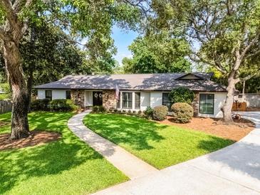 Charming one-story home with a well-manicured lawn and mature trees at 105 Laurel Oak Dr, Longwood, FL 32779