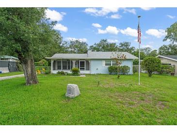 Charming single-story home with a well-manicured lawn and an American flag proudly displayed at 2538 Meadowview Ln, Deland, FL 32720