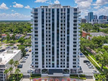 Tall white highrise condominium building with balconies and city views on a sunny day at 400 E Colonial Dr # 1501, Orlando, FL 32803
