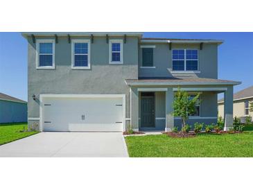 Charming two-story home with a two car garage and a well-maintained front yard at 766 Mocking Jay Ln, St Cloud, FL 34771