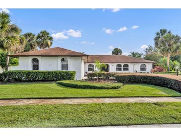Beautiful single-story home with lush landscaping and a well-manicured lawn under a bright, sunny sky at 137 N Spring Lake Dr, Altamonte Springs, FL 32714