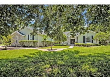 Charming home with a beautifully landscaped front yard and stone accents, providing great curb appeal at 14128 Bramble Bush Ct, Orlando, FL 32832