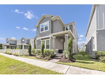 Beautiful two-story home with manicured lawn, inviting porch, and gray painted exterior at 640 Bayern Ln, Debary, FL 32713