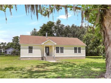 Charming single-story home with a neatly manicured lawn and cozy front porch at 28 N Osceola Ave, Center Hill, FL 33514