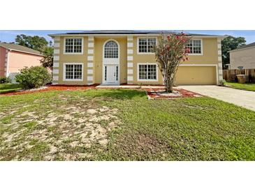 Two-story home featuring a manicured lawn and an attached two-car garage at 4209 Sw 33Rd St, Ocala, FL 34474