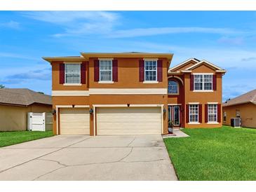 Charming two-story home featuring a well-maintained lawn and a spacious three-car garage at 447 Kehoe Blvd, Orlando, FL 32825