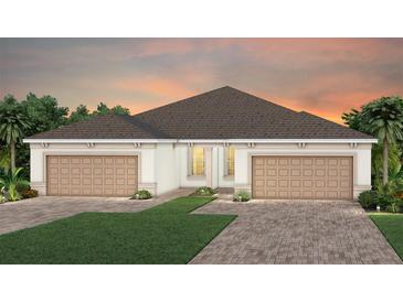 Beautiful home exterior with a two-car garage and well-manicured lawn, perfect for suburban living at 5174 Gardenrow Dr, St Cloud, FL 34772