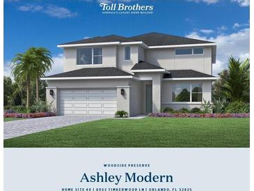 Two-story home featuring white stucco, a two-car garage, and beautifully landscaped yard at 8062 Timberwood Ln, Alafaya, FL 32825