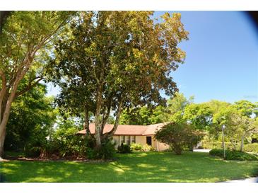 Charming one-story home nestled among mature trees and a well-maintained lawn at 1509 Huntington St, Deltona, FL 32725