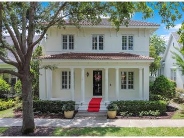 Charming two-story home featuring red tile roof, classic white pillars, and manicured landscaping at 1636 Hanks Ave, Orlando, FL 32814