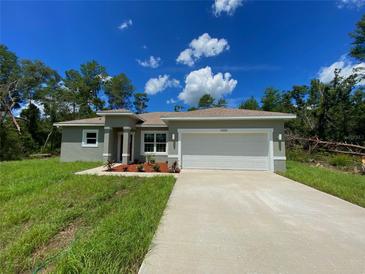 Charming single-story home with a two-car garage, manicured lawn, and freshly painted exterior at 16832 Sw 41St Avenue Rd, Ocala, FL 34473