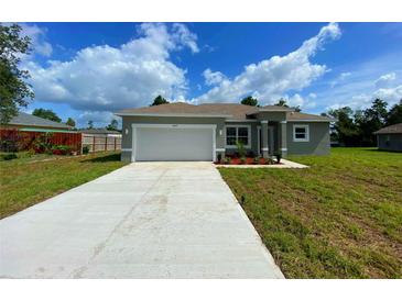 Charming single-story home with a two-car garage and well-maintained landscaping at 4437 Sw 159Th Pl, Ocala, FL 34473