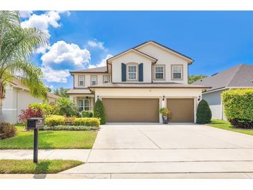 Beautiful two-story home with a three-car garage, manicured landscaping, and a well-maintained lawn at 561 Gunston Ct, Davenport, FL 33837