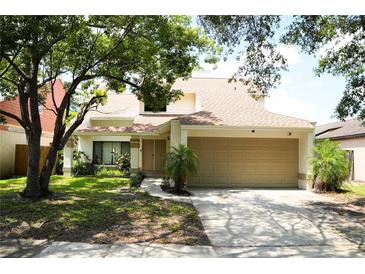 Charming two-story home with attached two-car garage and well-maintained lawn at 7939 Winter Song Dr, Orlando, FL 32825