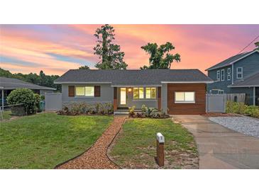 Charming single-story home featuring a landscaped front yard, updated siding, and a walkway to the front door at 840 Bethune Dr, Orlando, FL 32810