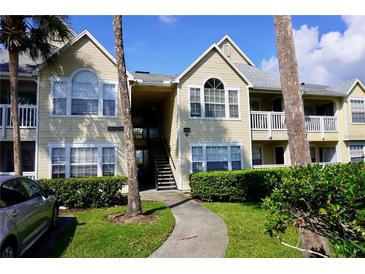 Inviting condo building featuring manicured landscaping, a stairway, and a well-maintained facade under a bright sky at 1031 S Hiawassee Rd # 2514, Orlando, FL 32835