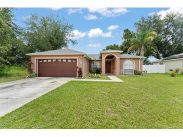Charming single-story home featuring a well-maintained lawn and a two-car garage at 470 Cardinal Ct, Kissimmee, FL 34759