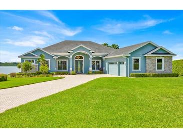 Beautiful home with a well-manicured lawn and a circular driveway at 5005 Shore Side Dr, Lakeland, FL 33812