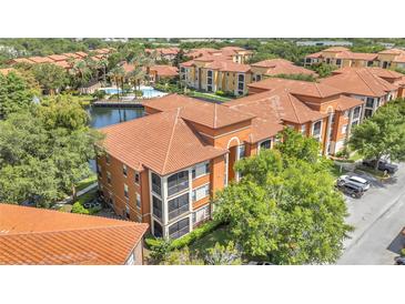 Beautiful waterfront condo featuring screened balconies and a classic tile roof at 6149 Metrowest Blvd # 103, Orlando, FL 32835